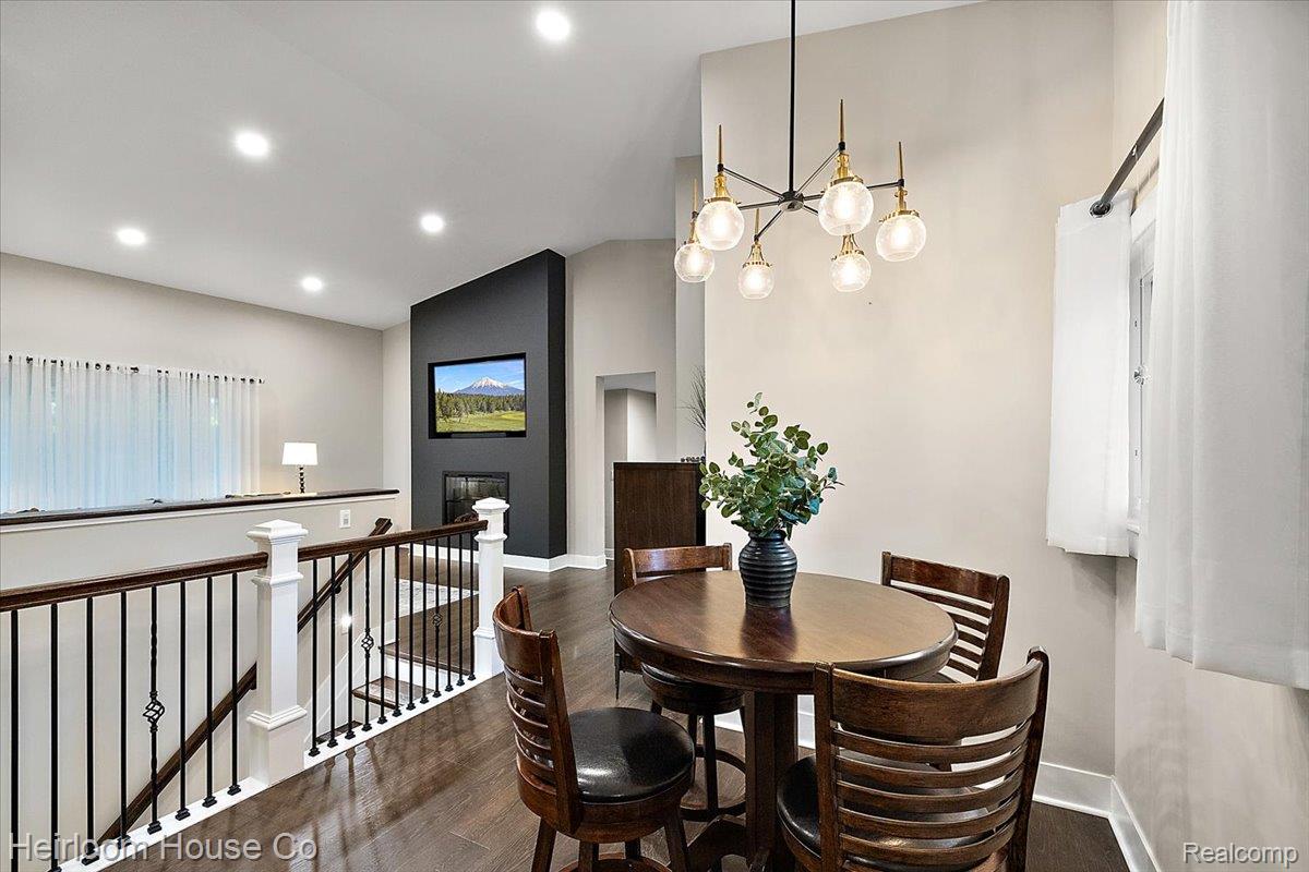 49001 Hanford Road Canton, MI 48187 - Photo 43 of 98 Open-concept dining area featuring a contemporary chandelier and dark wood-finish flooring