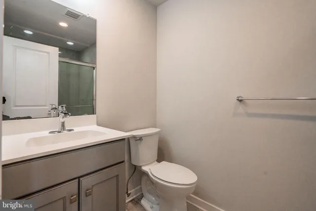 a bathroom with a sink toilet and vanity