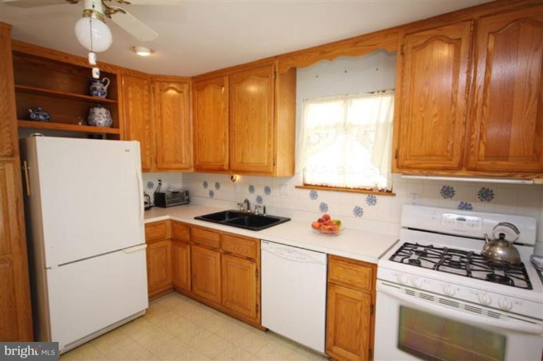 500 Forest View Road Linthicum Heights, MD 21090 - Photo 4 of 22 a kitchen with a white cabinets and white appliances