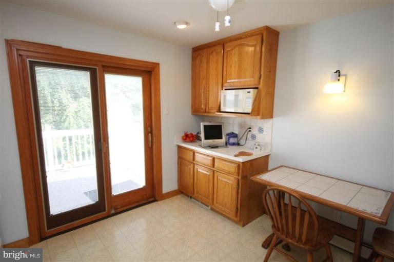 500 Forest View Road Linthicum Heights, MD 21090 - Photo 5 of 22 a kitchen that has a sink and a stove in it
