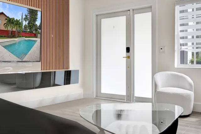 a view of a hallway with couch and a dining table