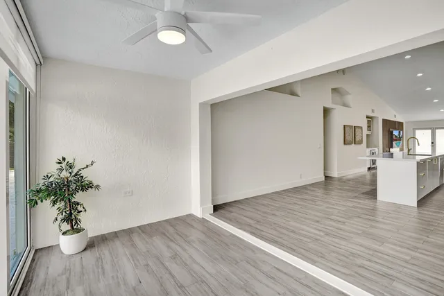 a large bed sitting in a bedroom next to a window