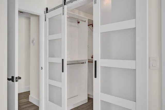 a view of a big house with a big yard and potted plants