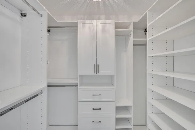 an aerial view of a house with a yard and lake view