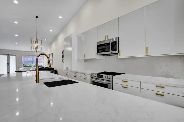 a kitchen with stainless steel appliances a stove and a refrigerator