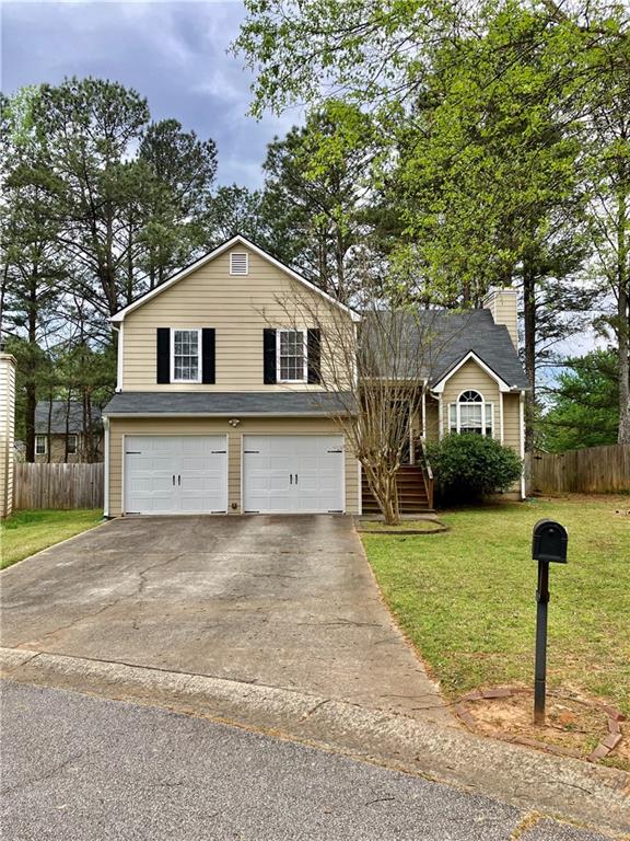 3878 Morning Dew Way Powder Springs, GA 30127 - Photo 1 of 1 a front view of a house with a yard and garage
