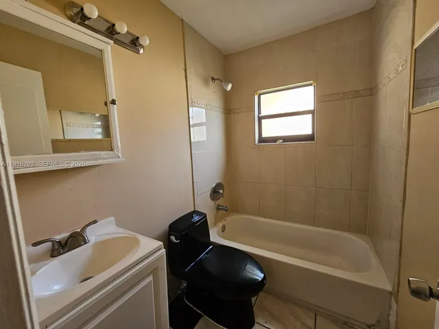 a bathroom with a sink a toilet and bathtub