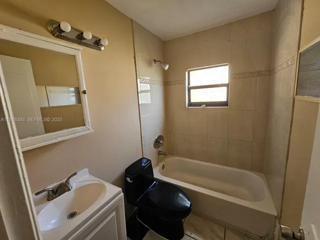 a bathroom with a tub sink and toilet