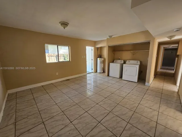 a view of a livingroom with wooden floor and furniture