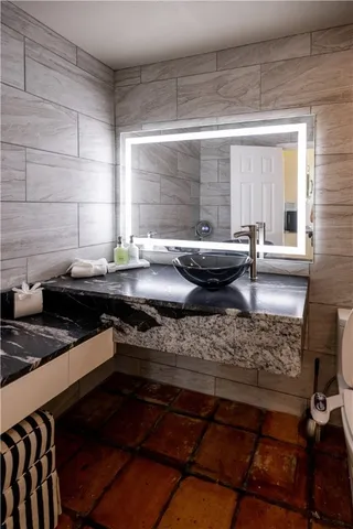 a kitchen with sink and view of living room