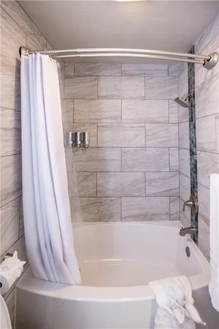 a bathroom with a bathtub and shower