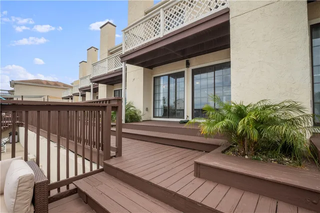a view of a patio with couches table and chairs and potted plants