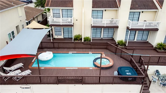 a view of a white house next to a yard with big trees