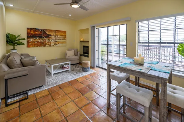 a living room with furniture and large window