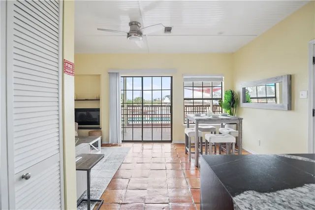 a living room with furniture a flat screen tv and a table