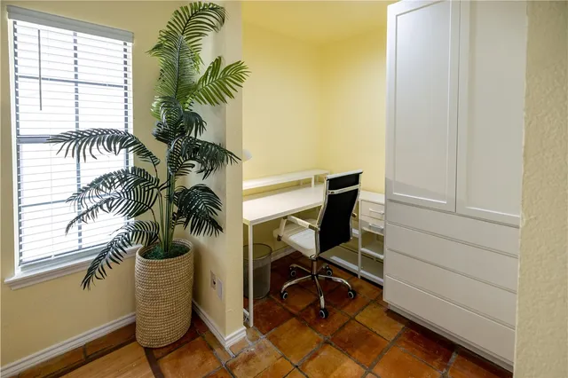a view of a room with a window and potted plant