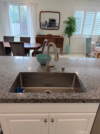 a kitchen with a sink and a granite counter top