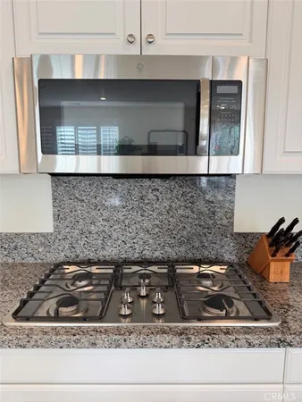 a kitchen with a stove and cabinets