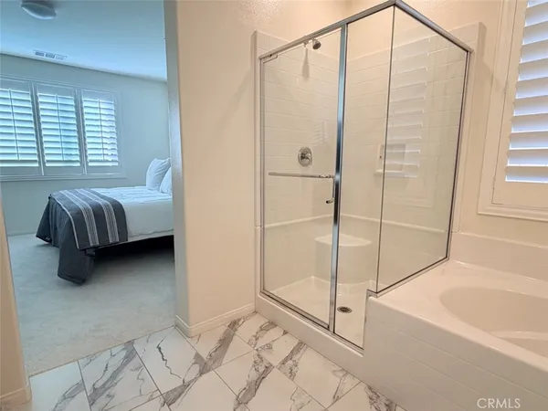 a bathroom with a bathtub shower sink and vanity