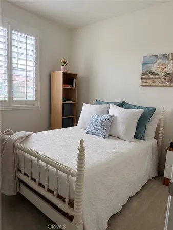 a bed room with a bed and a window