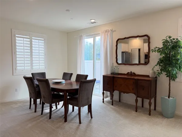 a living room with furniture potted plant and a table