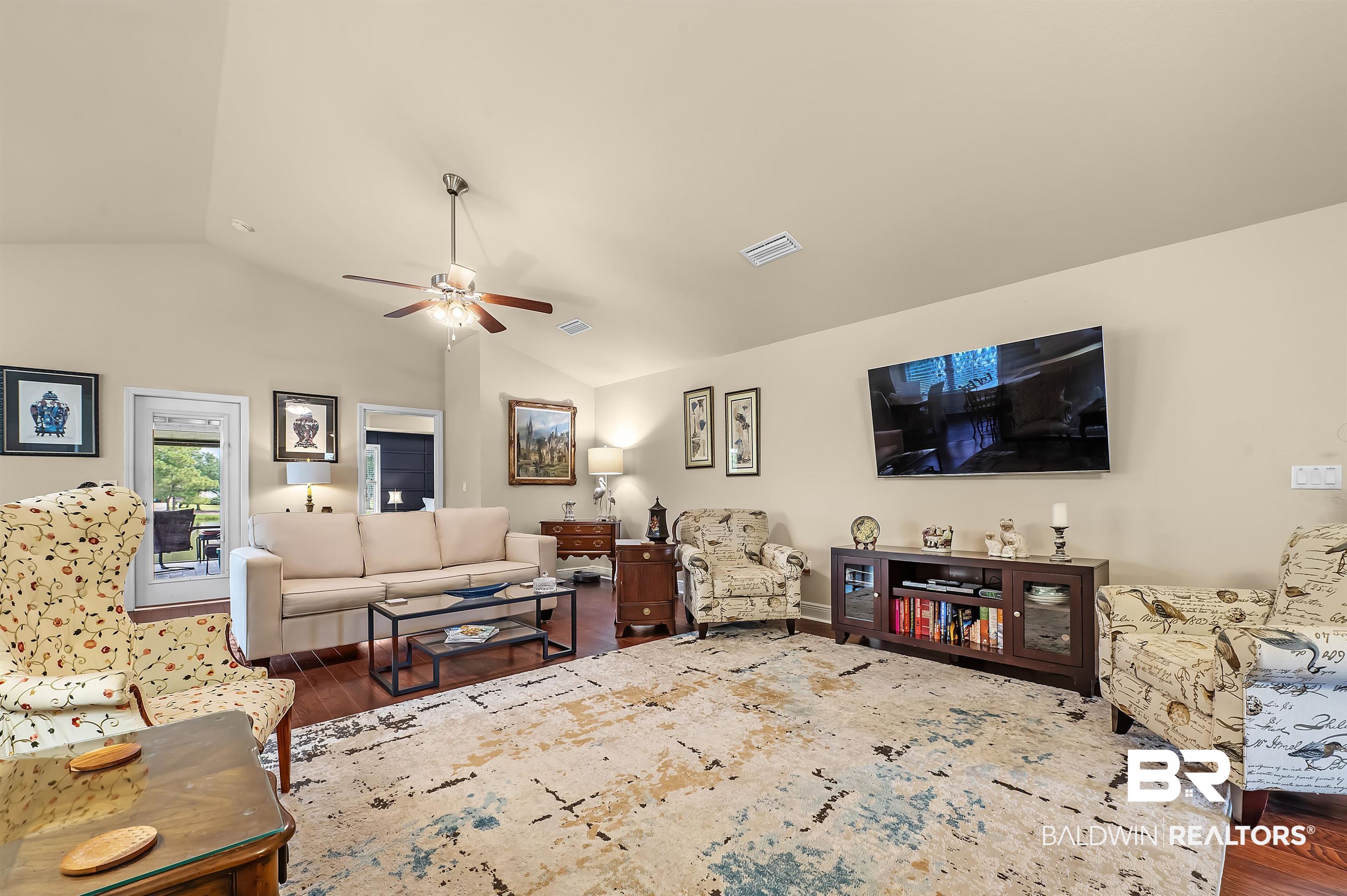 8896 Allay Lane Foley, AL 36535 - Photo 35 of 57 Living room with ceiling fan, wood-type flooring, and vaulted ceiling