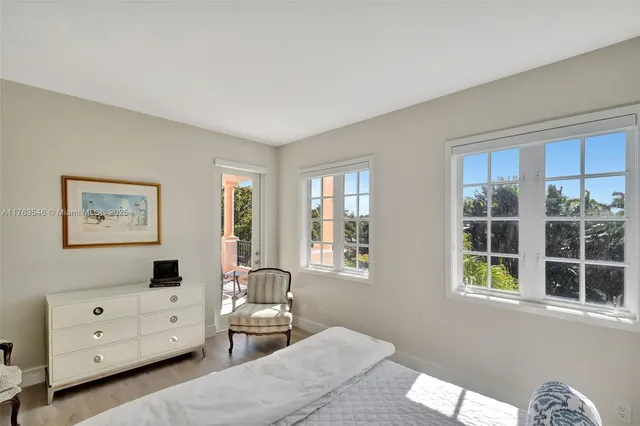 a bedroom with furniture and a window