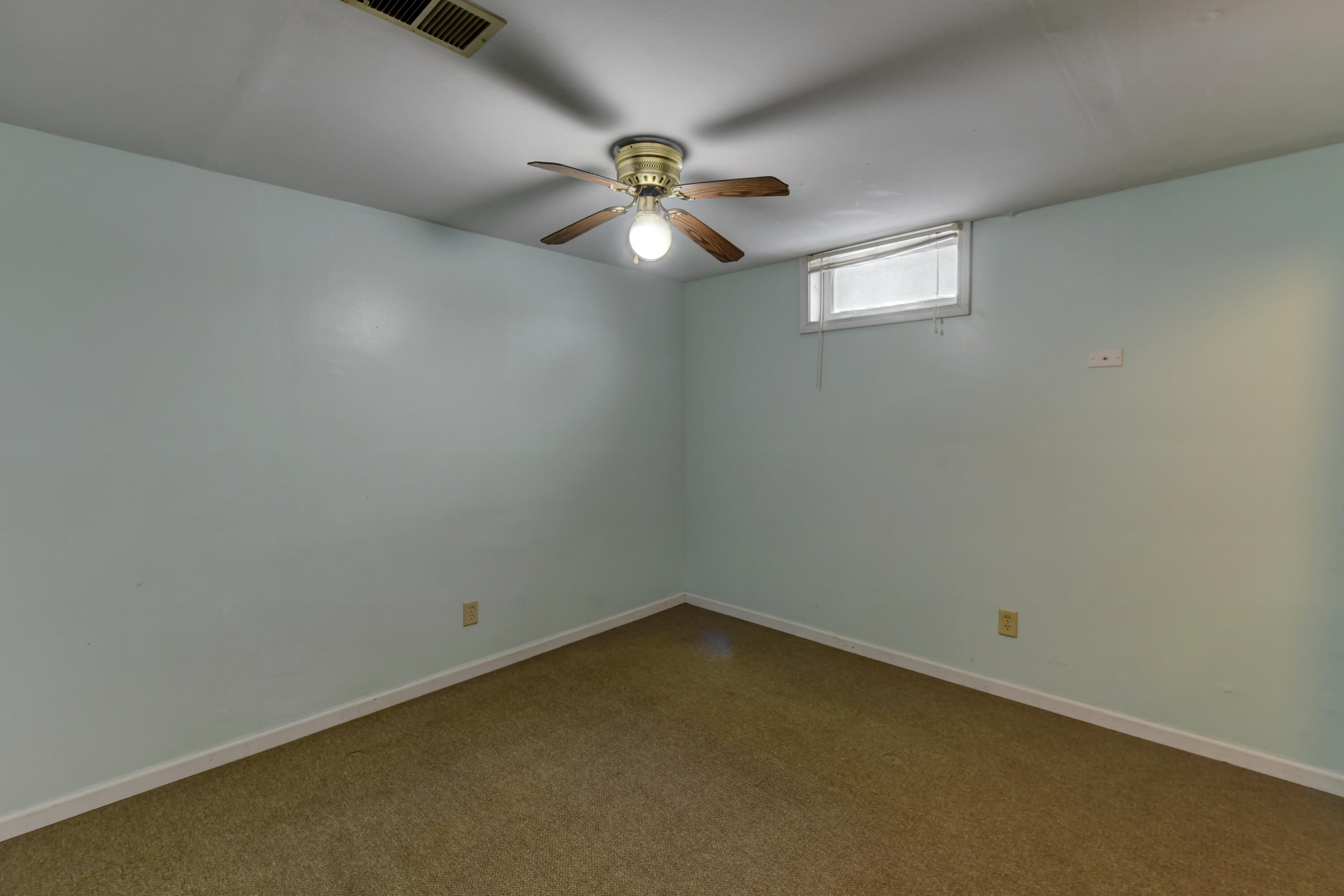 902 North Wood Street Griffith, IN 46319 - Photo 11 of 17 an empty room with a ceiling fan and window