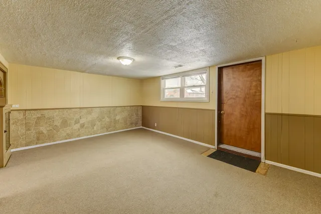 an empty room with a empty space and windows