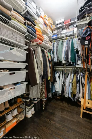 a view of walk in closet with clothes and shoes
