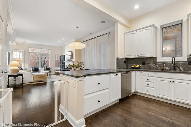 a large white kitchen with cabinets