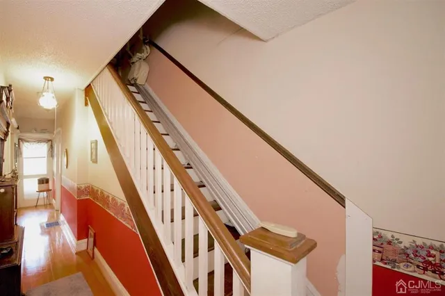 a bedroom with a bed lamp on table and a window
