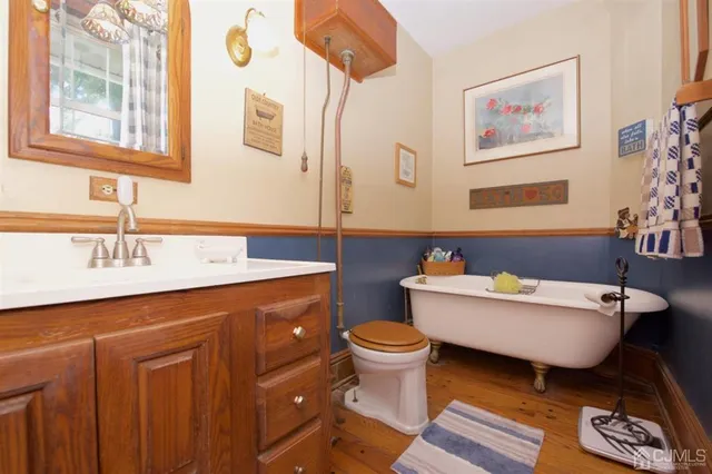 a view of a swimming pool with a yard and large trees