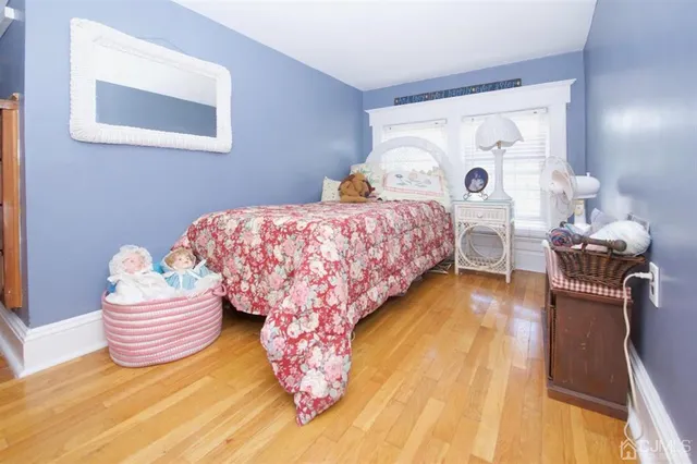 a view of a house with a yard and large trees