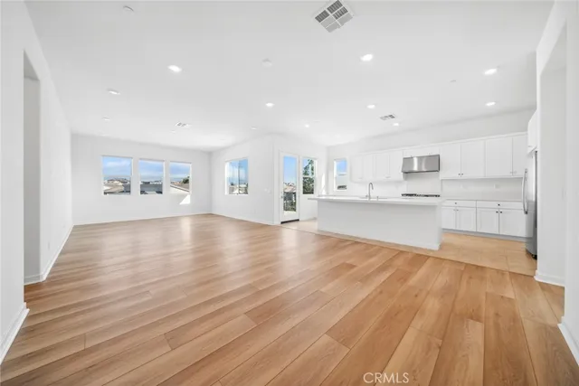 a view of a kitchen with cabinets and wooden floor