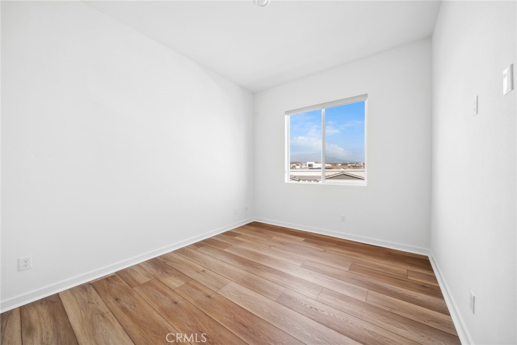 111 Baluster Irvine, CA 92618 - Photo 14 of 30 a view of an empty room with wooden floor and a window