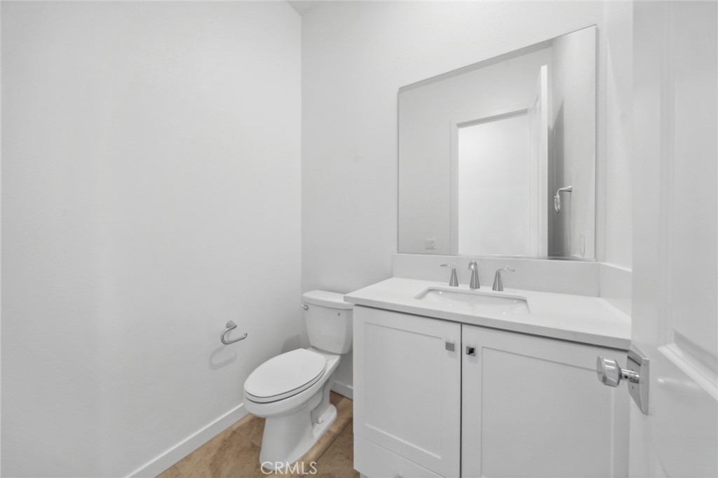 111 Baluster Irvine, CA 92618 - Photo 16 of 30 a bathroom with a granite countertop toilet sink and mirror