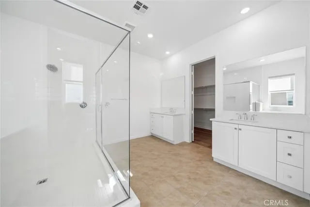 a bathroom with a granite countertop sink mirror and a bathtub