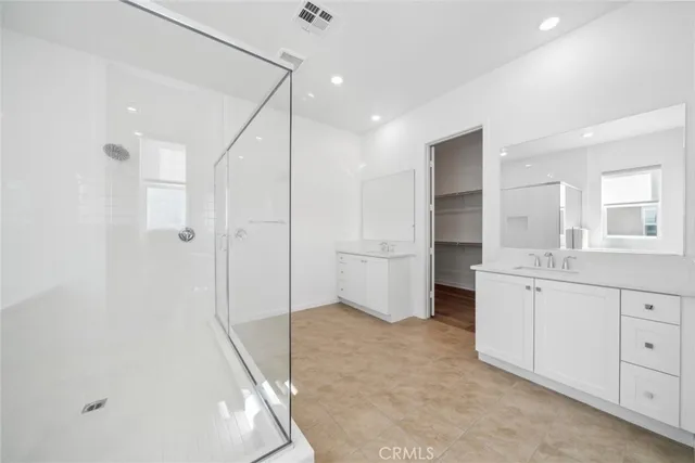a bathroom with a granite countertop sink mirror and a bathtub