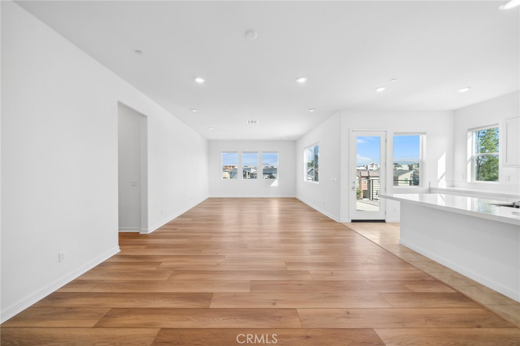 111 Baluster Irvine, CA 92618 - Photo 7 of 30 a view of an empty room and kitchen with wooden floor