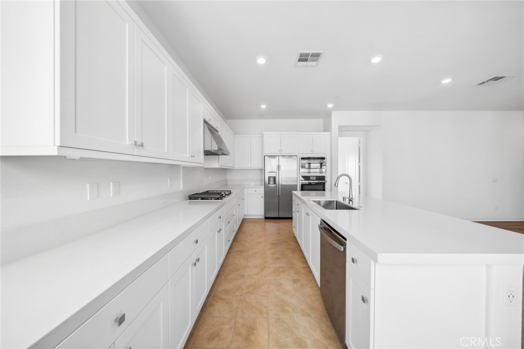 111 Baluster Irvine, CA 92618 - Photo 8 of 30 a large kitchen with stainless steel appliances granite countertop a lot of counter space and wooden floors