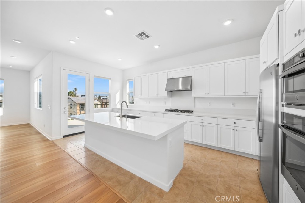 111 Baluster Irvine, CA 92618 - Photo 10 of 30 a large white kitchen with cabinets