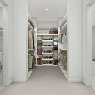 a view of walk in closet with white walls