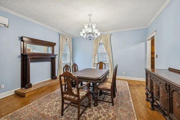a view of a livingroom with wooden floor and a ceiling fan