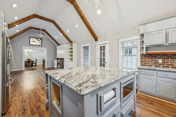 a kitchen with granite countertop sink stove and refrigerator