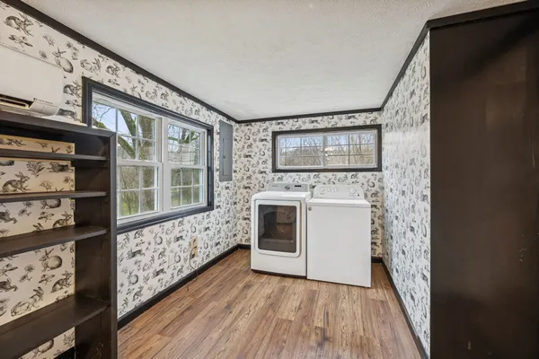 a view of a room with wooden floor and a ceiling fan