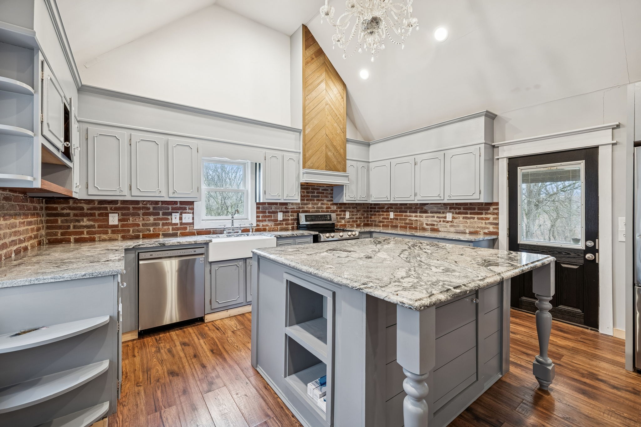 5360 Bunker Hill Road Pulaski, TN 38478 - Photo 33 of 69 a kitchen with stainless steel appliances granite countertop a stove a sink dishwasher a microwave oven and a dining table with wooden floor