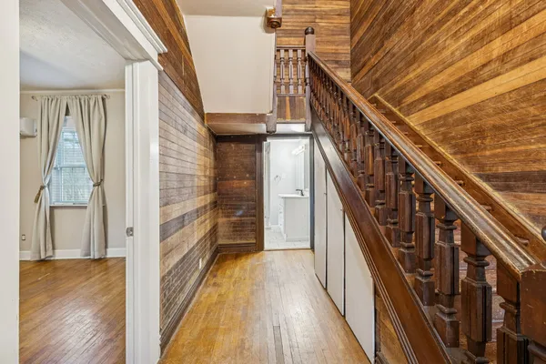 a view of an empty room with wooden floor