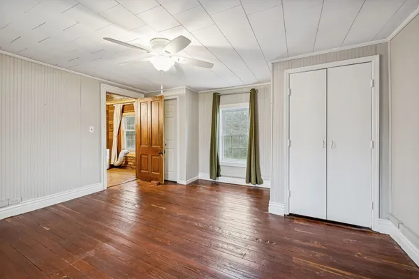 a view of a room with wooden floor