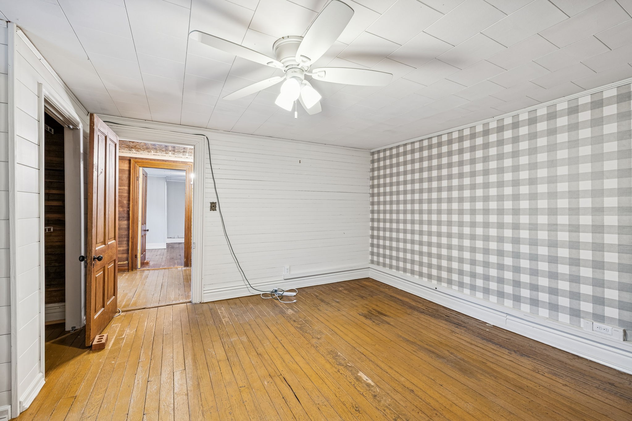 5360 Bunker Hill Road Pulaski, TN 38478 - Photo 48 of 69 a view of an empty room with wooden floor and a chandelier fan